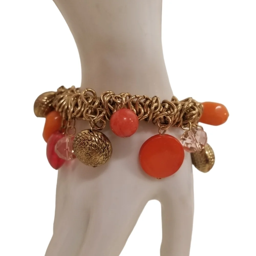 GOLDTONED STRETCH BRACELET WITH BOLD ORANGE & RED GLASS & ACRYLIC CHARMS